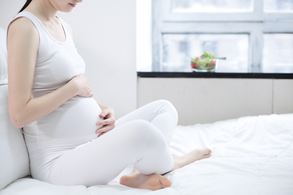 healthy nutrition and pregnancy. pregnant woman's belly and vegetable salad