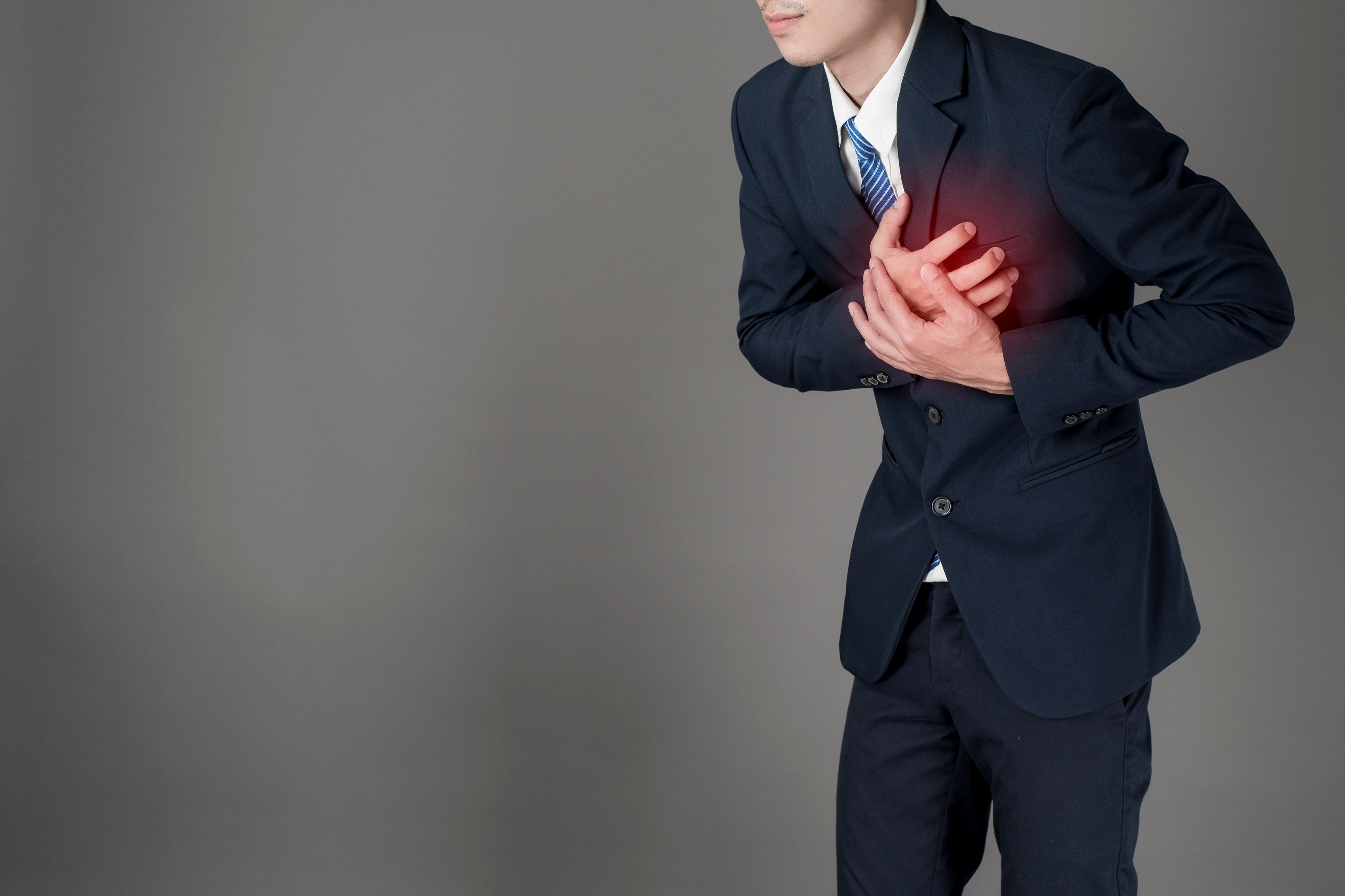 Business man is heart attack  ,grey background in studio